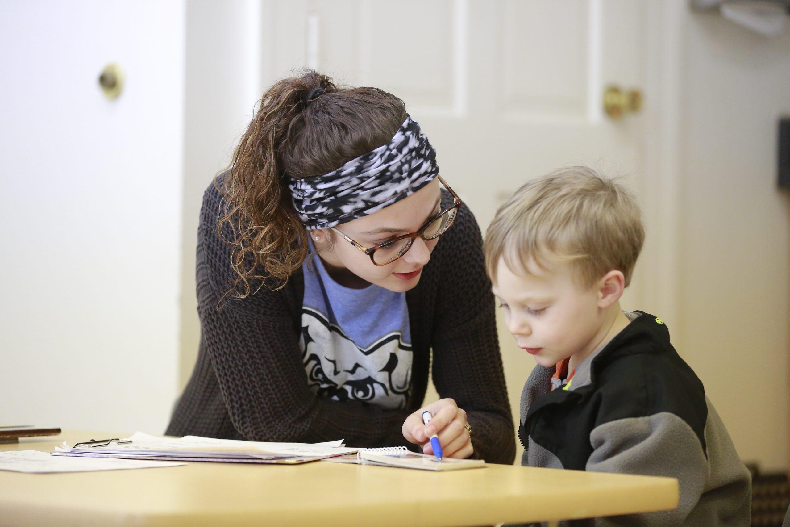 a student working with a preschooler