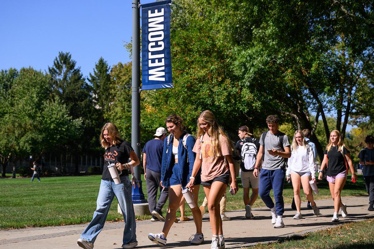 Students walking down a pathway on campus